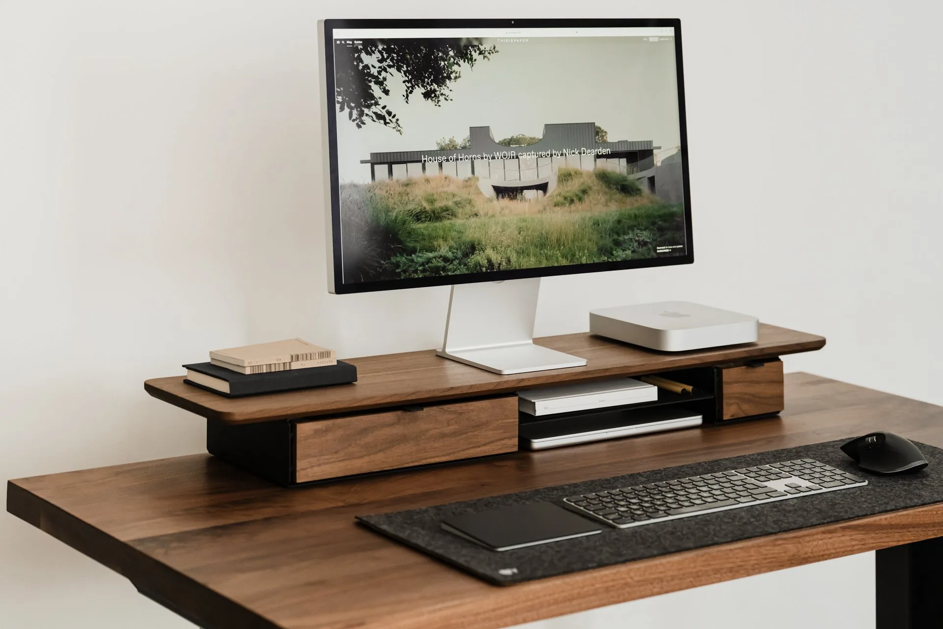 Walnut Deskshelf Pro holding a monitor on a desk