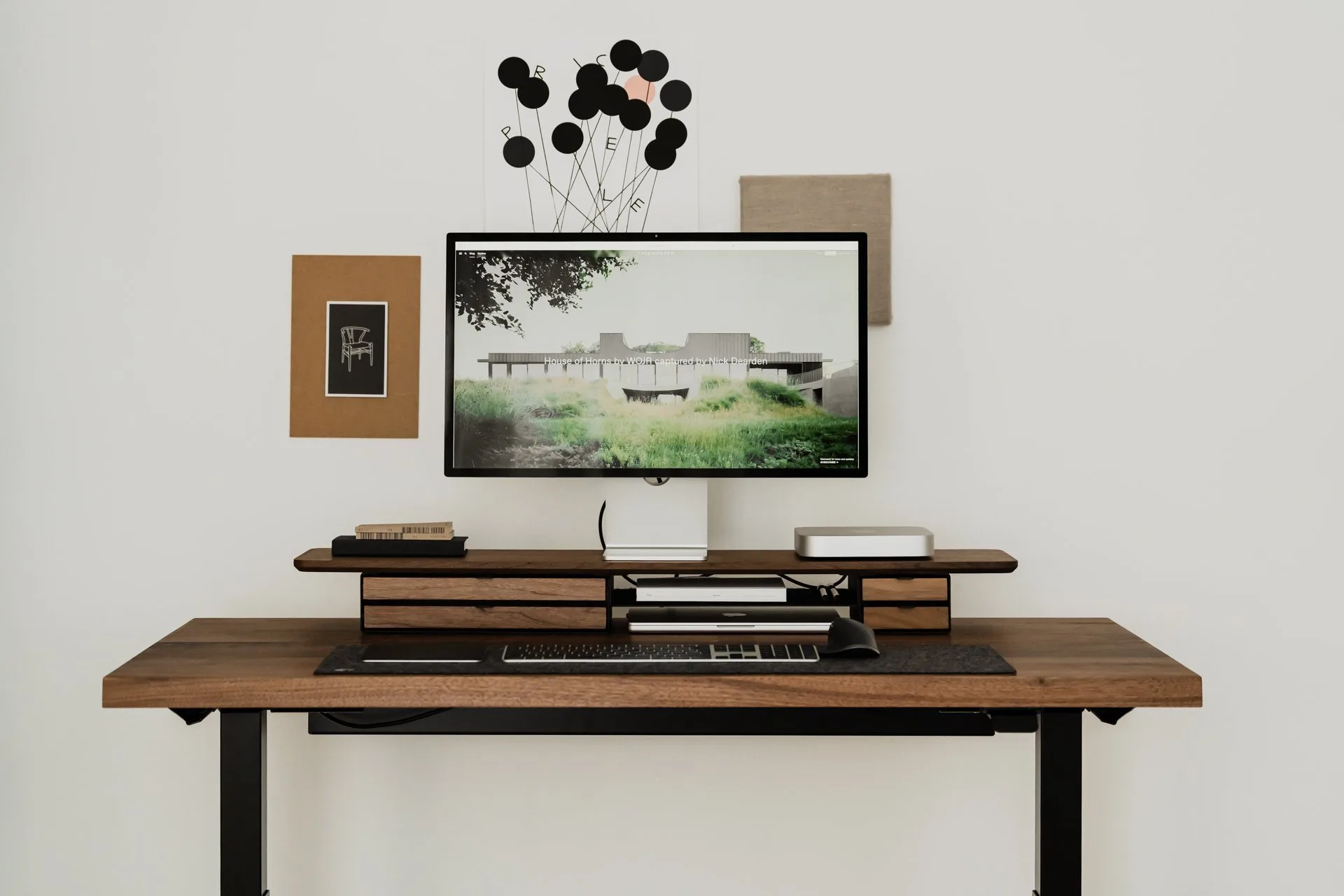 Walnut Deskshelf Pro on a desk in a bright room