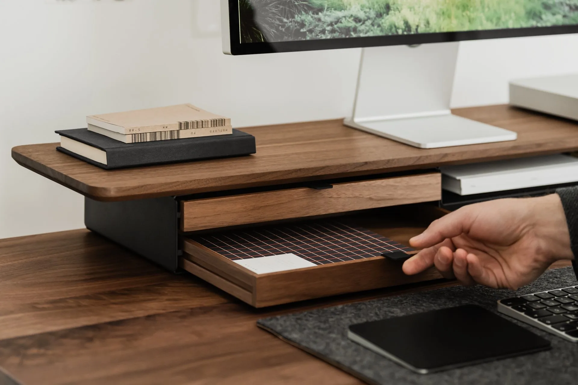 Hand opening a drawer in a walnut Deskshelf Pro