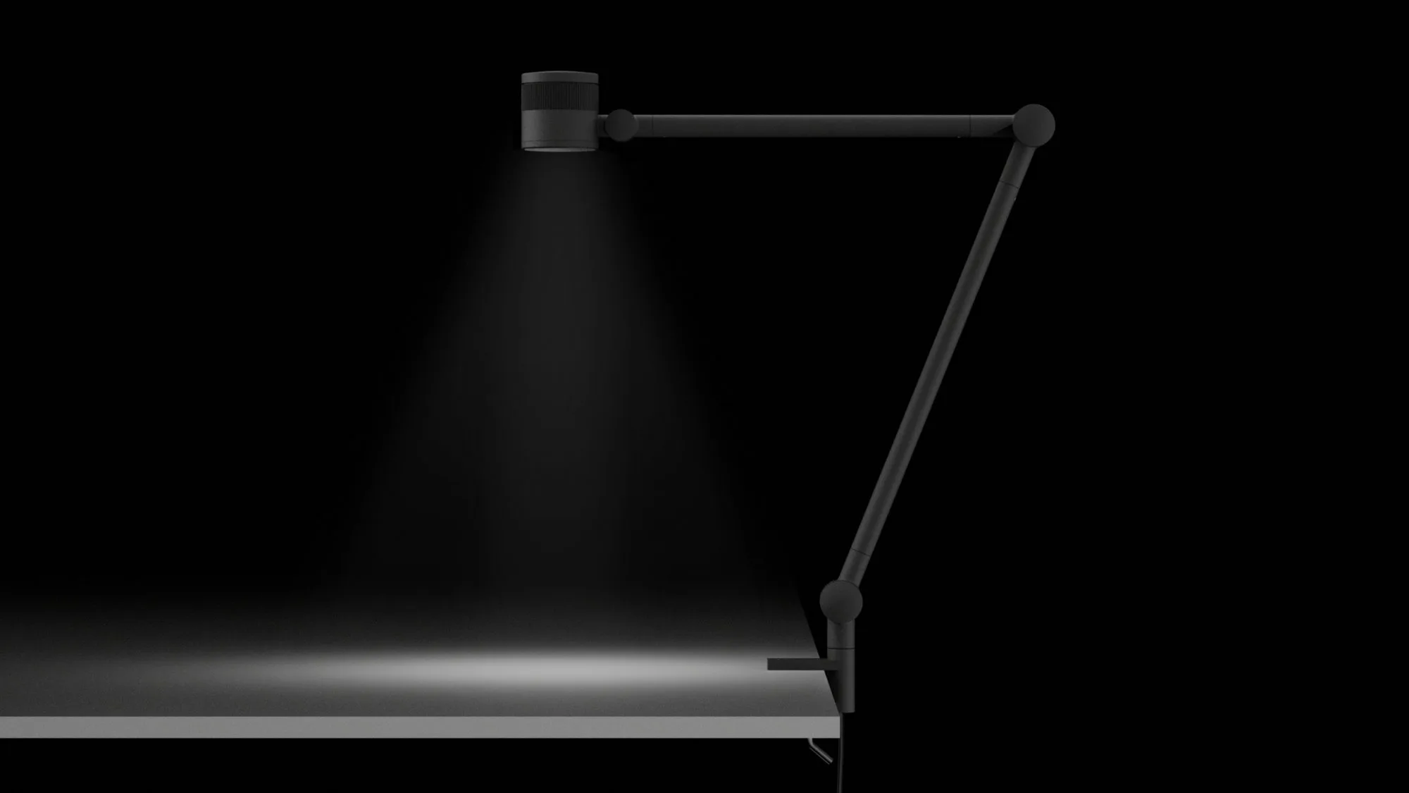 FOCAL lamp in the dark, casting a narrow beam onto a desk