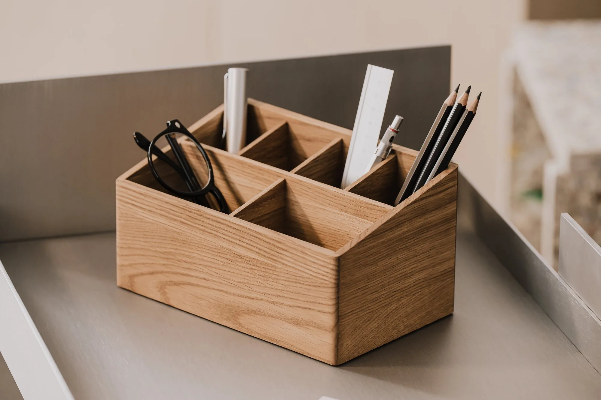 Oak desk organiser holding pens, a ruler and glasses