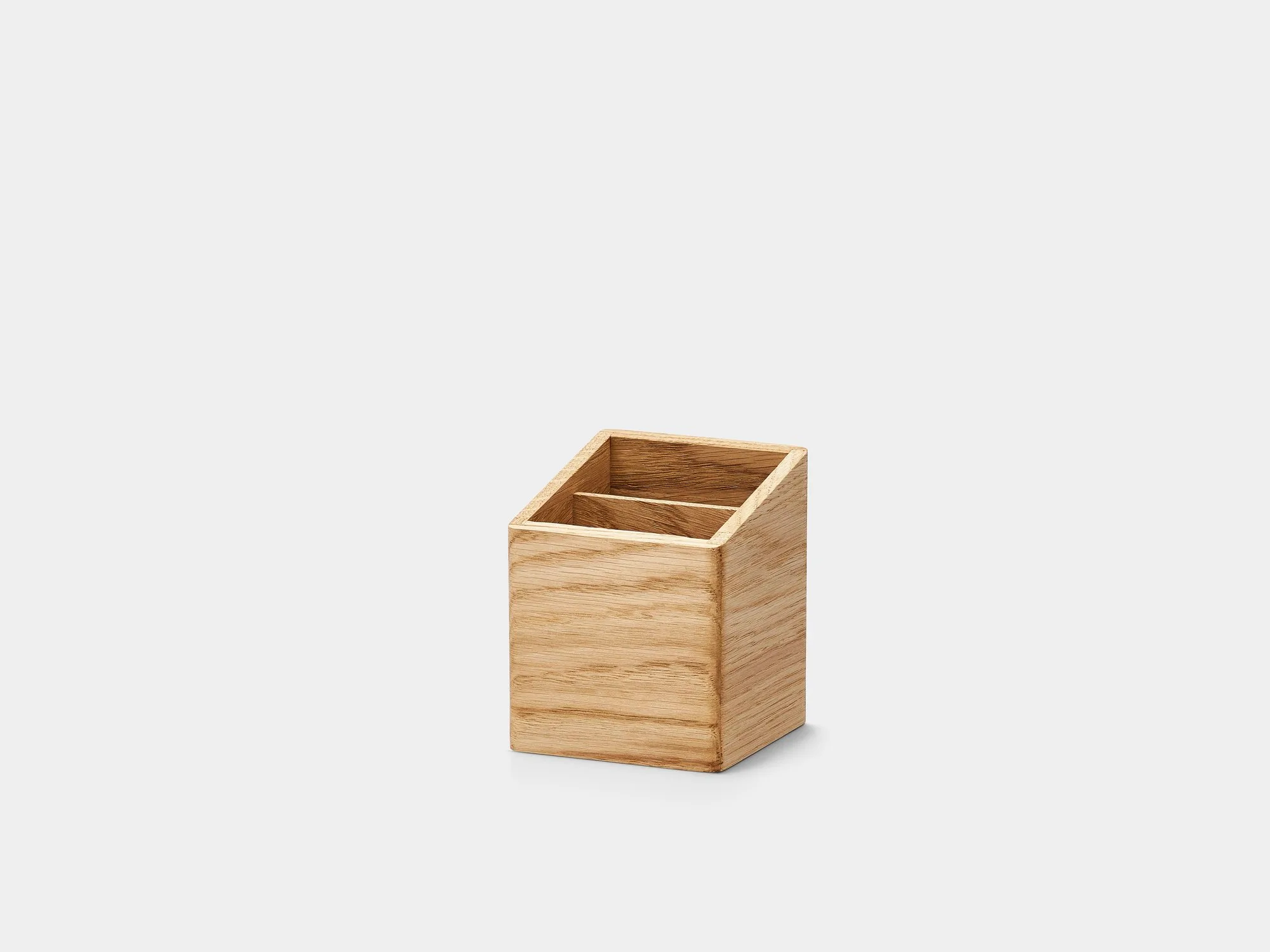 Small oak pen holder on a grey background