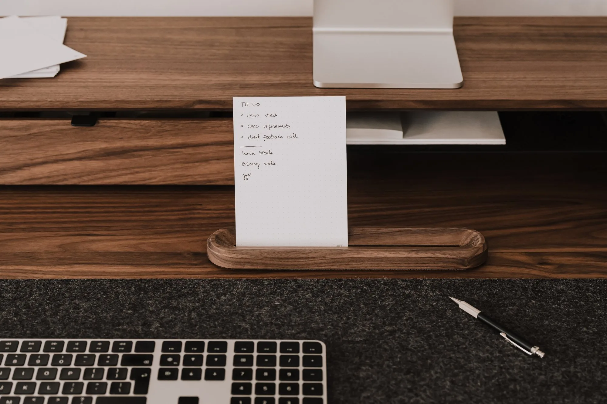 Walnut card holder with a card in front of a monitor shelf