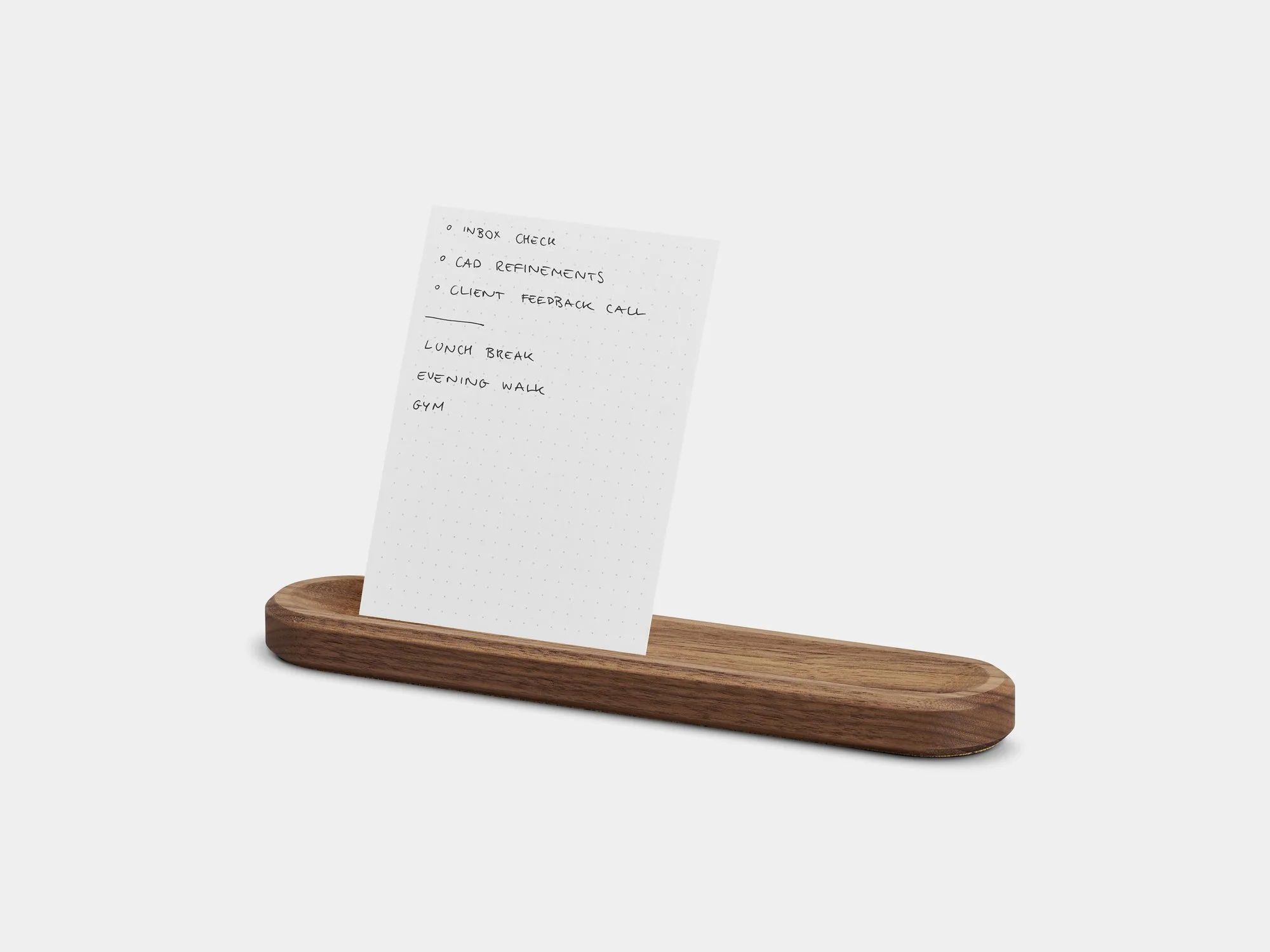 Walnut card holder with a card on a grey background