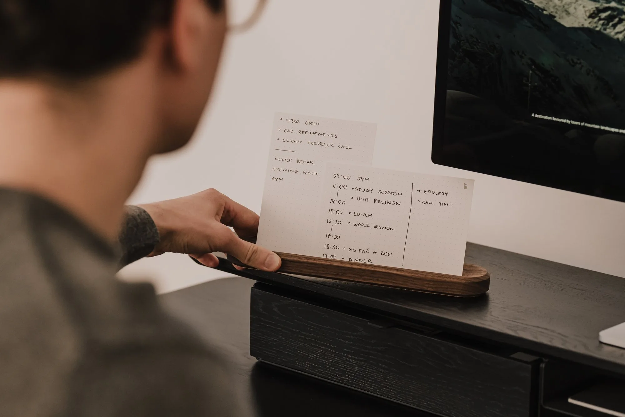 Person placing a card into a walnut holder